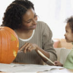 single mother carving pumpkin