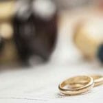 wedding rings next to gavel