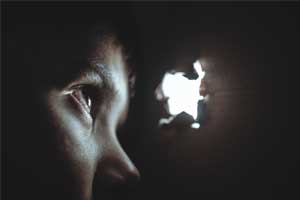 child looking through hole
