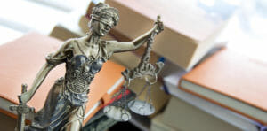 Statue with books | Criminal Defense Lawyer